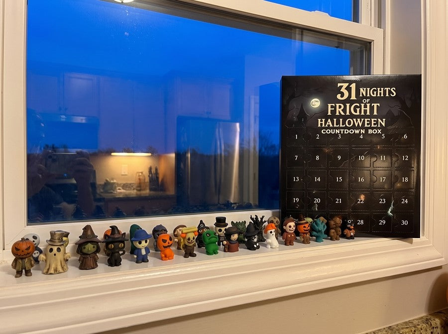 The set lined up along the windowsill at dusk